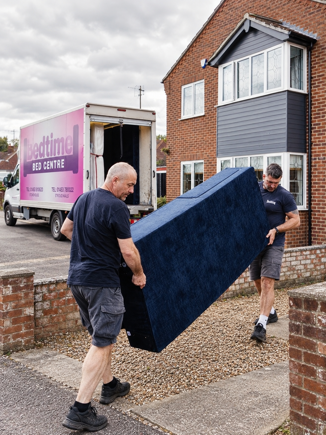 Bedtime Bed Centre delivery team carrying a bed into a customer's home.